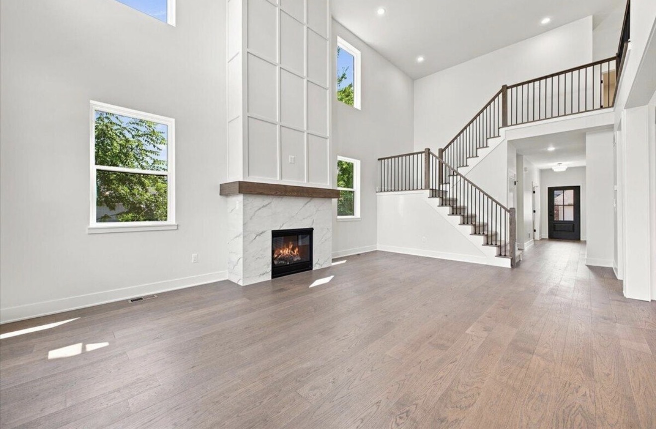 Two-story great room with fireplace and open staircase